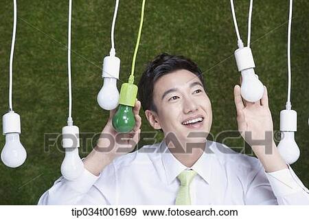 man sticking his head out of the bulbs hanging on the ceiling View Large Photo Image Stock Photo - man sticking his head out of the bulbs hanging on the ceiling . Fotosearch