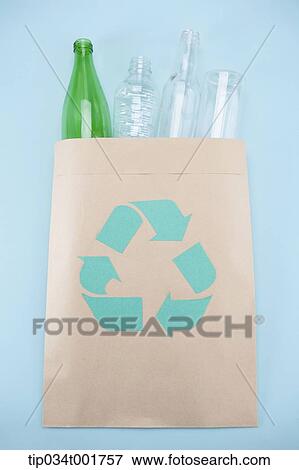 recyclable materials in the paper bag with recycling sign View Large Photo Image Stock Photo - recyclable materials in the paper bag with recycling sign . Fotosearch