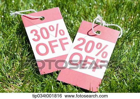Stock Photograph - sale tag on the grass. Fotosearch
