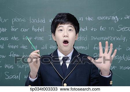 schoolboy holding a pen and thinking of an idea View Large Photo Image Stock Image - schoolboy holding a pen and thinking of an idea . Fotosearch