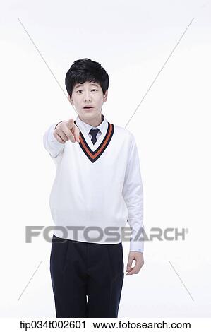Stock Image - schoolboy pointing out with his index finger. Fotosearch