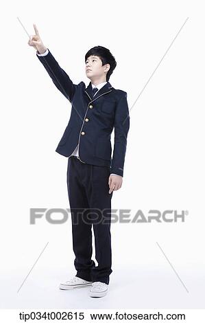 Stock Photography - schoolboy pointing out with his index finger. Fotosearch