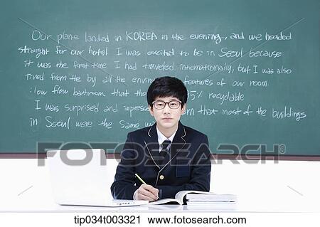 schoolboy studying hard in front of the blackboard with computer View Large Photo Image Stock Image - schoolboy studying hard in front of the blackboard with computer. Fotosearch