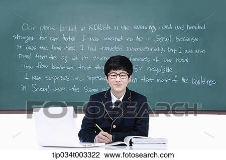 schoolboy studying hard in front of the blackboard with computer View Large Photo Image Stock Image - schoolboy studying hard in front of the blackboard with computer. Fotosearch