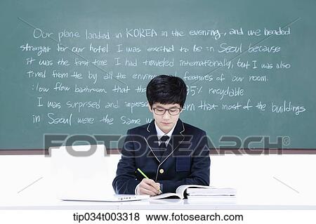schoolboy studying hard in front of the blackboard with computer View Large Photo Image Stock Photo - schoolboy studying hard in front of the blackboard with computer. Fotosearch