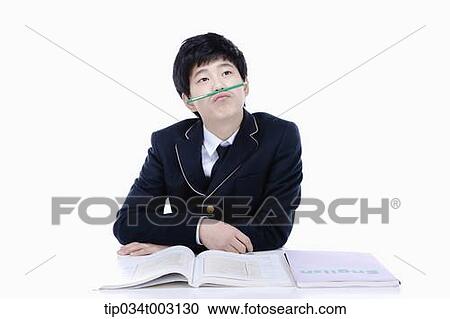 schoolboy studying hard with a pen on the bridge of his nose View Large Photo Image Stock Image - schoolboy studying hard with a pen on the bridge of his nose. Fotosearch