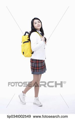 schoolgirl carrying a yellow-colored schoolbag View Large Photo Image Stock Photo - schoolgirl carrying a yellow-colored schoolbag. Fotosearch