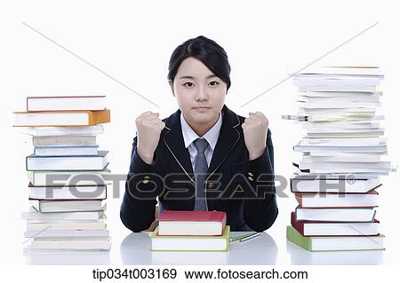 schoolgirl clenching her fists to study hard View Large Photo Image Stock Photo - schoolgirl clenching her fists to study hard. Fotosearch