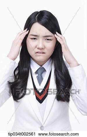 Stock Image - schoolgirl having a headache. Fotosearch