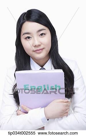 Stock Photography - schoolgirl holding a folder with her arms. Fotosearch