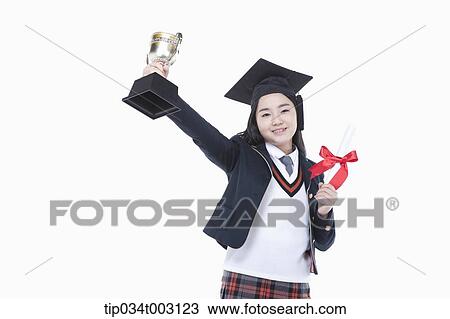 Stock Image - schoolgirl holding graduation certification and trophy . Fotosearch
