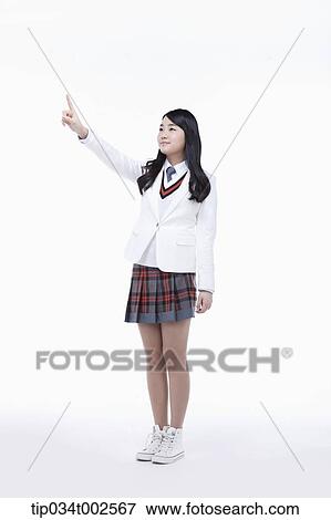 Stock Photo - schoolgirl pointing out with her index finger. Fotosearch