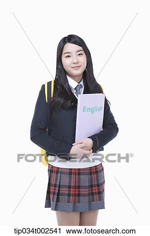 schoolgirl standing and holding a folder View Large Photo Image Stock Image - schoolgirl standing and holding a folder. Fotosearch