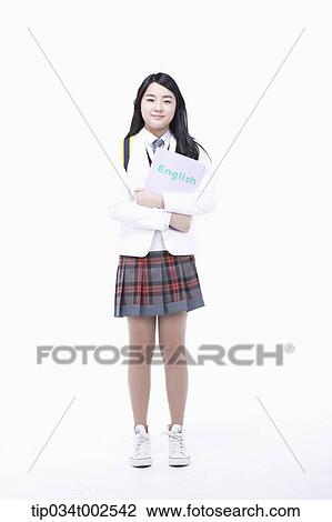 Stock Image - schoolgirl standing and holding a folder. Fotosearch