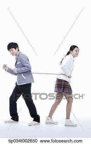 Stock Image - students pulling a string toward opposite side each other. Fotosearch