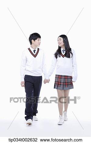 Stock Image - students walking hand in hand. Fotosearch