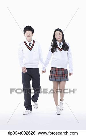 Stock Photograph - students walking hand in hand. Fotosearch