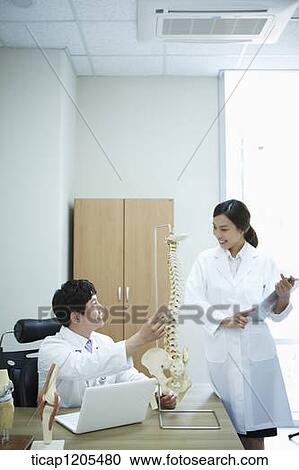 Surgeons discussing in a office View Large Photo Image Stock Image - Surgeons discussing in a office . Fotosearch