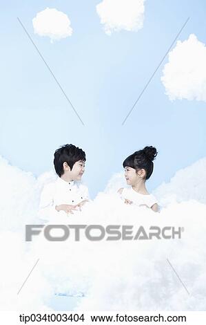 two kids with looks of angels on the clouds View Large Photo Image Picture - two kids with looks of angels on the clouds. Fotosearch