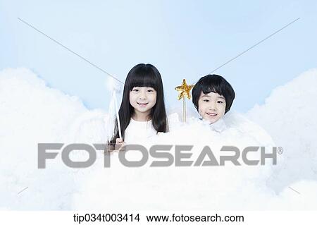 Picture - two kids with looks of angels on the clouds. Fotosearch