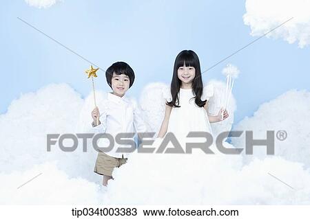 Stock Image - two kids with looks of angels on the clouds. Fotosearch