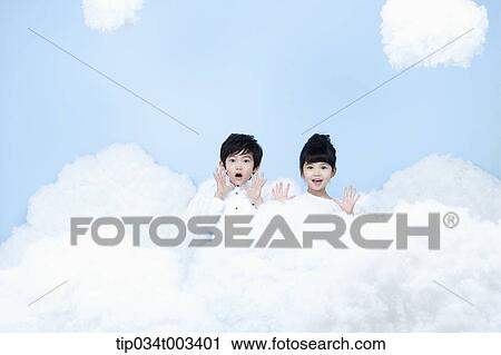 Stock Image - two kids with looks of angels on the clouds. Fotosearch
