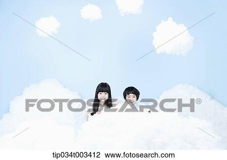 Stock Image - two kids with looks of angels on the clouds. Fotosearch