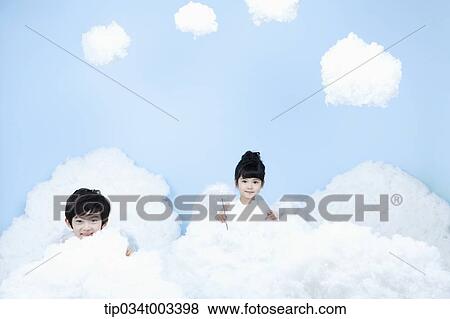 Stock Photo - two kids with looks of angels on the clouds. Fotosearch