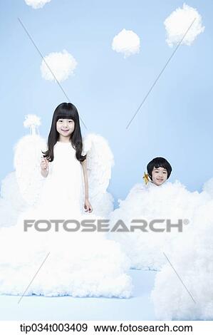 Stock Photo - two kids with looks of angels on the clouds. Fotosearch
