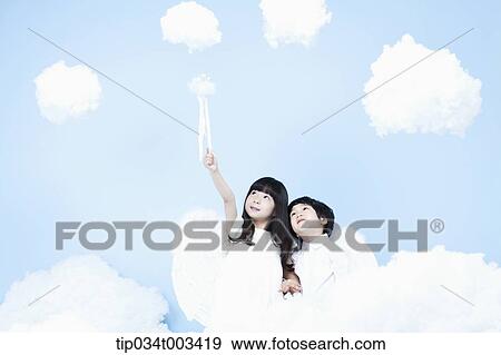 Stock Photo - two kids with looks of angels on the clouds. Fotosearch