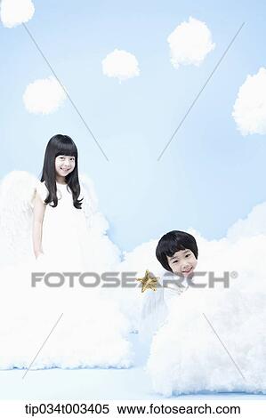 Stock Photography - two kids with looks of angels on the clouds. Fotosearch