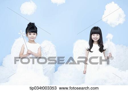 Stock Image - two little girls with looks of angels on the clouds. Fotosearch