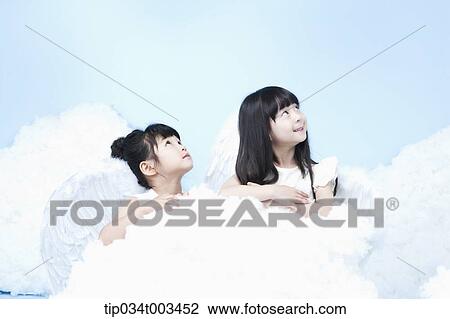 two little girls with looks of angels on the clouds View Large Photo Image Stock Image - two little girls with looks of angels on the clouds. Fotosearch
