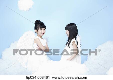 two little girls with looks of angels on the clouds View Large Photo Image Stock Image - two little girls with looks of angels on the clouds. Fotosearch