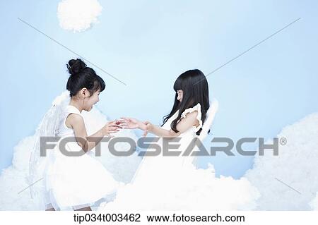 two little girls with looks of angels on the clouds View Large Photo Image Stock Image - two little girls with looks of angels on the clouds. Fotosearch