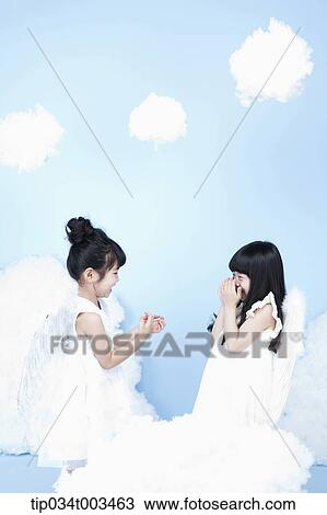 two little girls with looks of angels on the clouds View Large Photo Image Stock Image - two little girls with looks of angels on the clouds. Fotosearch