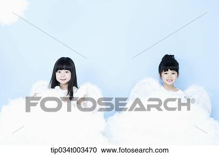 Stock Image - two little girls with looks of angels on the clouds. Fotosearch