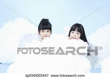 two little girls with looks of angels on the clouds View Large Photo Image Stock Photo - two little girls with looks of angels on the clouds. Fotosearch