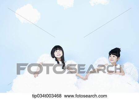 Stock Photo - two little girls with looks of angels on the clouds. Fotosearch
