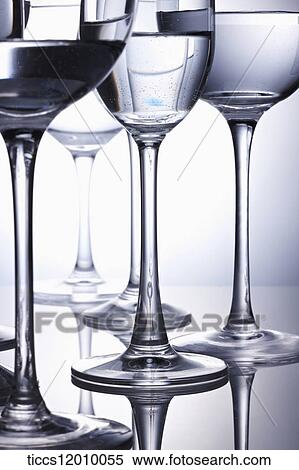 Stock Photography - Wine glasses filled with water positioned in a diamond shape. Fotosearch