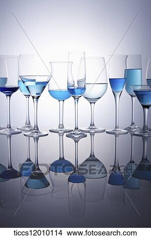 Picture - Wine glasses in different size and shape filled with blue cocktails. Fotosearch