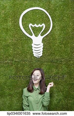 Stock Photography - woman coming up with idea together under the bulb. Fotosearch
