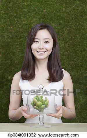 woman grabbing a crystal box of a plant View Large Photo Image Stock Image - woman grabbing a crystal box of a plant . Fotosearch