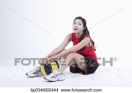 Picture - woman holding a beach ball . Fotosearch