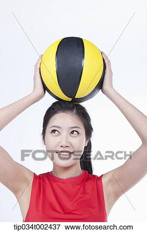 Stock Photo - woman holding a beach ball . Fotosearch