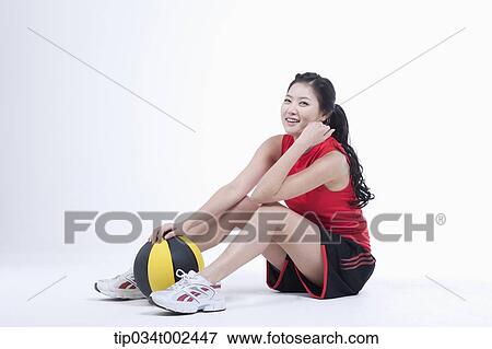 Stock Photo - woman holding a beach ball . Fotosearch