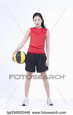 Stock Photo - woman holding a beach ball . Fotosearch