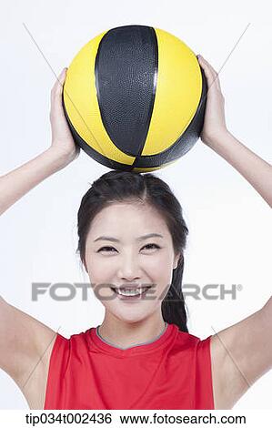 Stock Photograph - woman holding a beach ball . Fotosearch