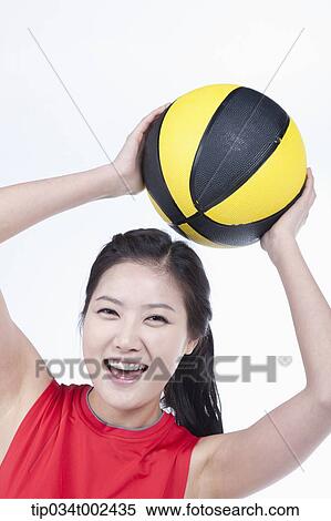 Stock Photography - woman holding a beach ball . Fotosearch