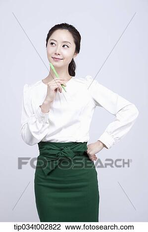 woman holding a green pen View Large Photo Image Stock Image - woman holding a green pen. Fotosearch